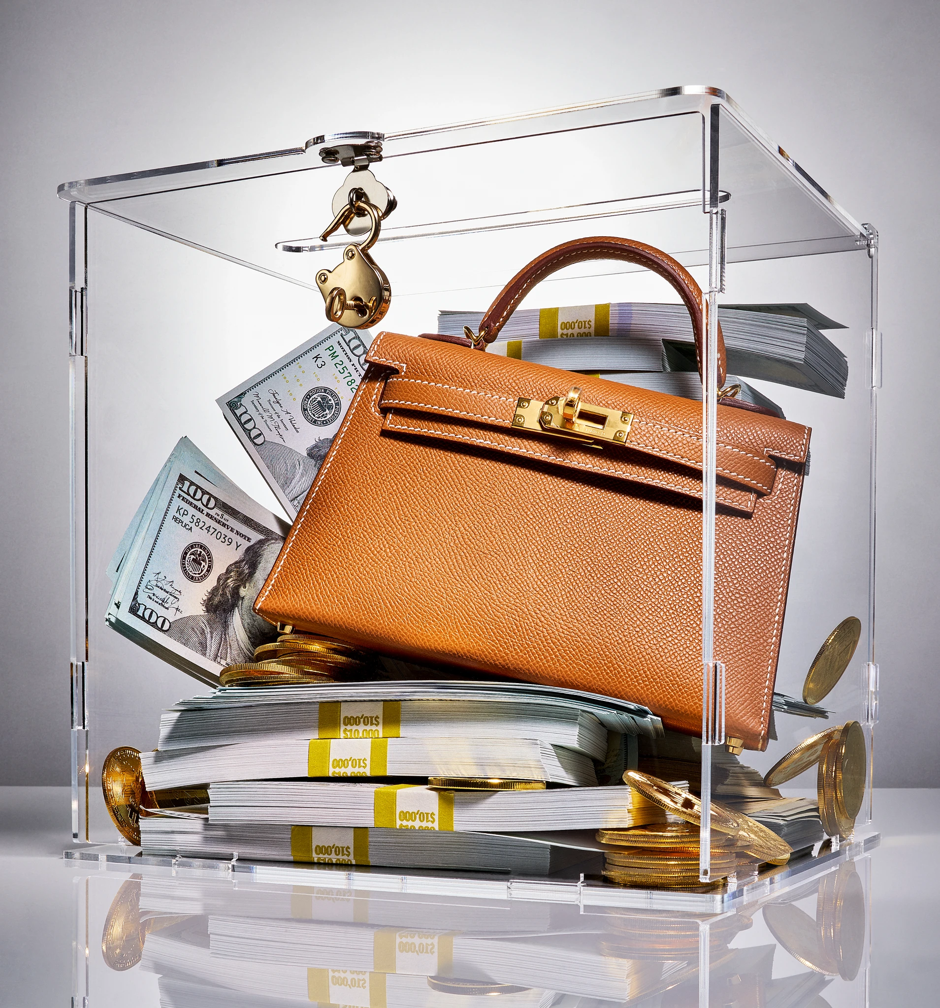 Hermès handbag in glass display case with money