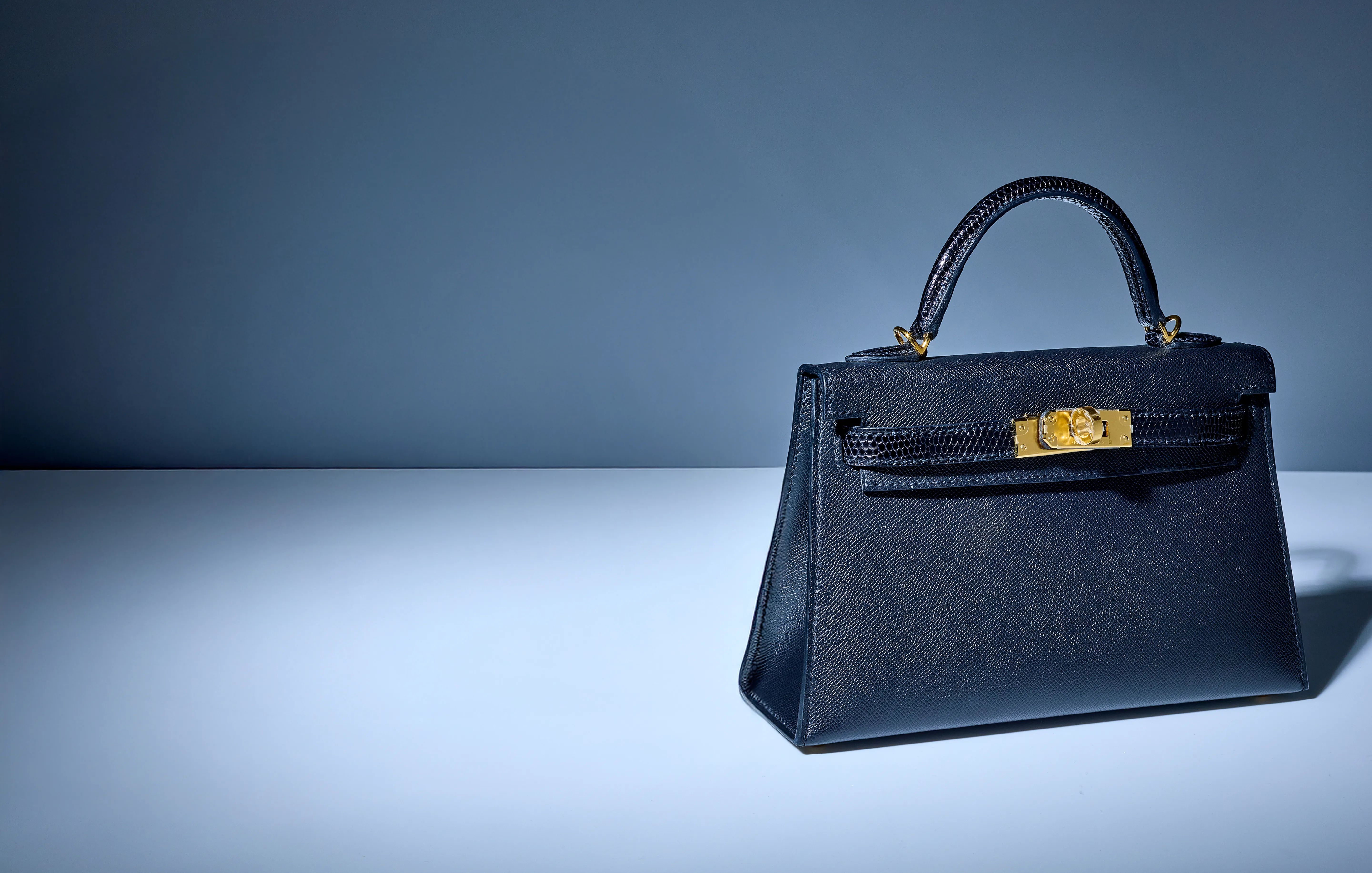 Luxury handbag on gradient background